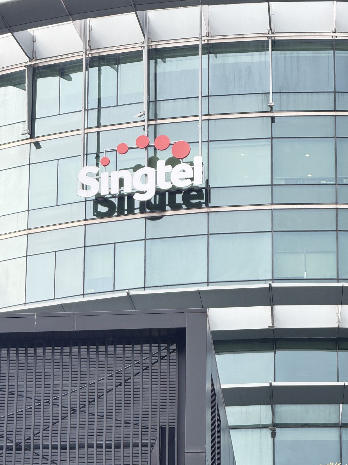 Singtel — exterior lettering · glass facade